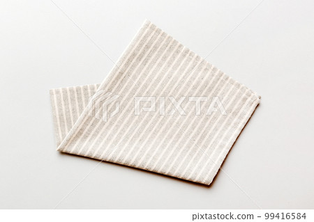 top view with gray kitchen napkin isolated on table background. Folded cloth for mockup with copy space, Flat lay. Minimal style top view with gray kitchen napkin isolated on table background. Folded cloth for mockup with copy space, Flat lay. Minimal style 99416584