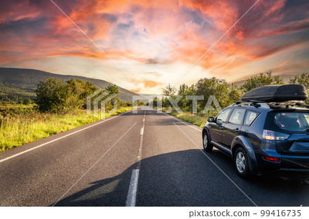 car for traveling with a mountain road 99416735