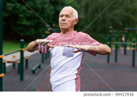 Old man warming up before training outdoors Old man warming up before training outdoors 99417016