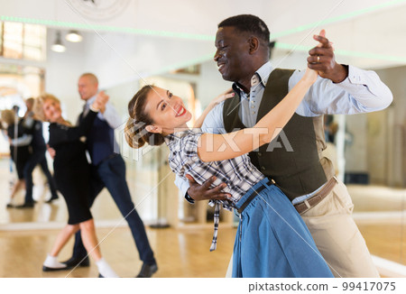 Woman with american man practising ballroom dancing Woman with american man practising ballroom dancing 99417075