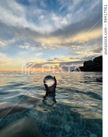 Beautiful scenic view through lens of crystal ball at summer sunset. Beautiful scenic view through lens of crystal ball at summer sunset. 99417561
