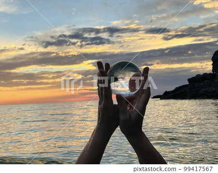 Beautiful scenic view through lens of crystal ball at summer sunset. Beautiful scenic view through lens of crystal ball at summer sunset. 99417567