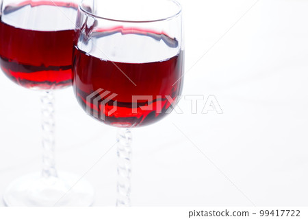 Two wine glasses filled with red wine Two wine glasses filled with red wine 99417722
