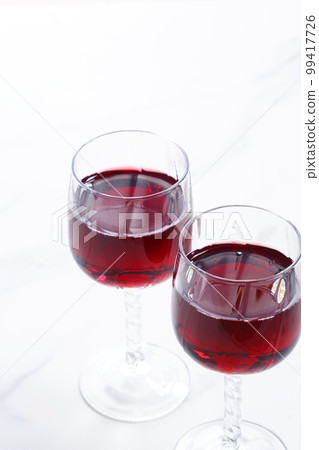 Two wine glasses filled with red wine Two wine glasses filled with red wine 99417726