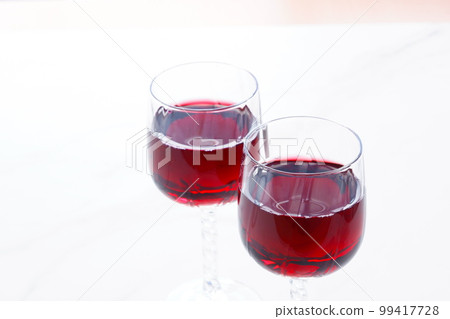 Two wine glasses filled with red wine 99417728