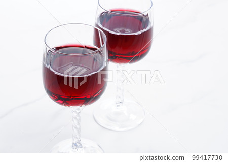 Two wine glasses filled with red wine Two wine glasses filled with red wine 99417730