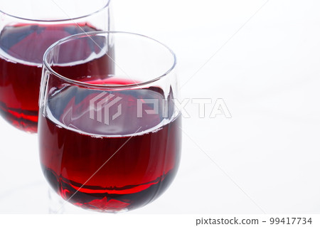Two wine glasses filled with red wine Two wine glasses filled with red wine 99417734