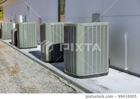 Outside air conditioning system unit has been installed on concrete foundation of near house exterior 99418005