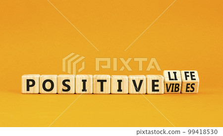 Positive vibes and life symbol. Concept words Positive vibes or Positive life on wooden cubes. Beautiful orange table orange background. Business positive vibes life concept. Copy space Positive vibes and life symbol. Concept words Positive vibes or Positive life on wooden cubes. Beautiful orange table orange background. Business positive vibes life concept. Copy space 99418530