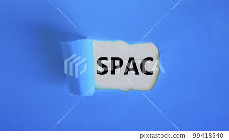 SPAC, special purpose acquisition company symbol. Words 'SPAC' appearing behind torn blue paper. Beautiful blue background, copy space. Business and SPAC, special purpose acquisition company concept. 99418540