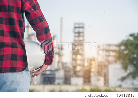 Engineer woman hands holding hardhat white work helmet hard hat for Construction Engineering. Refinery woman engineer oil industry hands hold worker helmet hard hat. Refinery industry engineering 99418815