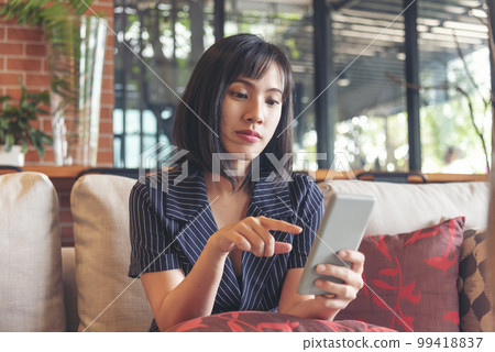 Asian woman holding smartphone with E-commerce Shopping online website Reading Online Article, Blog, vlog. Young Woman hands holding phone technology lifestyle. Happy Woman using digital smart phone Asian woman holding smartphone with E-commerce Shopping online website Reading Online Article, Blog, vlog. Young Woman hands holding phone technology lifestyle. Happy Woman using digital smart phone 99418837