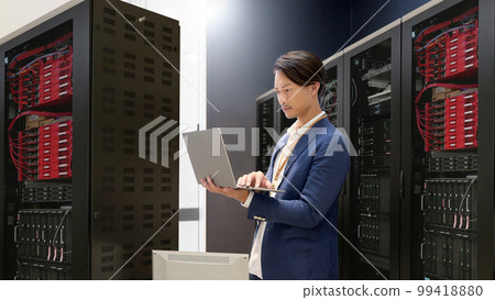Information system staff checking computers in the server room Information system business image 99418880