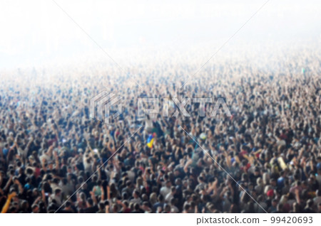 Blurred crowd of people partying 99420693