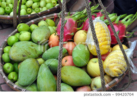 Basket full with exotic fruits in a market. Vietnam Basket full with exotic fruits in a market. Vietnam 99420704