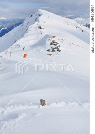 Skiers skiing on piste Skiers skiing on piste 99420994