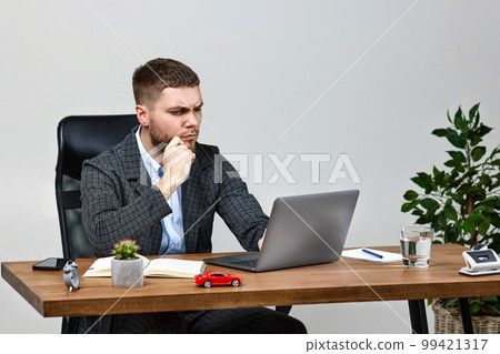 man sitting on chair at table and resting, using laptop man sitting on chair at table and resting, using laptop 99421317