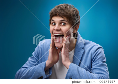 shocked man with surprise expression and excited face 99421557