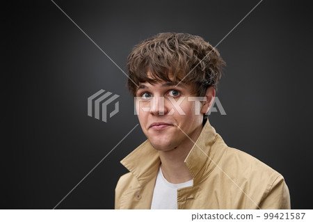 portrait of caucasian man with hairstyle in coat 99421587