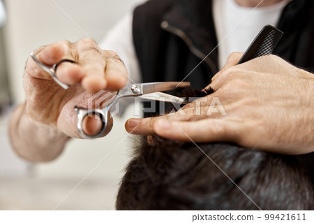 Professional hairdresser does haircut for caucasian bearded man Professional hairdresser does haircut for caucasian bearded man 99421611