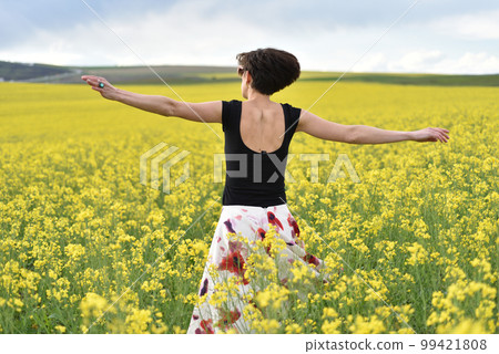 Young woman enjoying freedom in the outdoors Young woman enjoying freedom in the outdoors 99421808