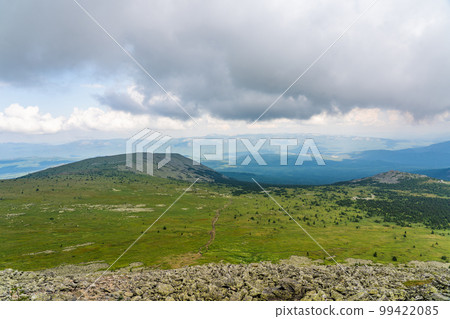 Forests and mountains of the Southern Urals near the village of Tyulyuk in Russia. Drone view. Forests and mountains of the Southern Urals near the village of Tyulyuk in Russia. Drone view. 99422085