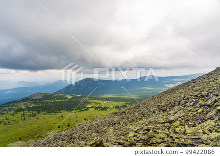 Forests and mountains of the Southern Urals near the village of Tyulyuk in Russia. Drone view. Forests and mountains of the Southern Urals near the village of Tyulyuk in Russia. Drone view. 99422086