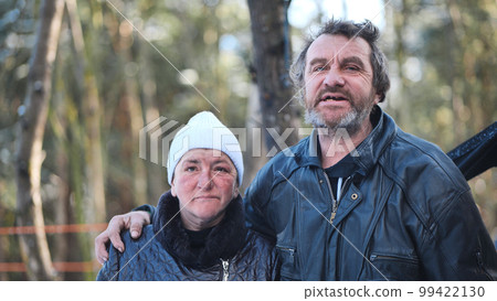 Homeless people are interviewed in the winter in the woods. 99422130