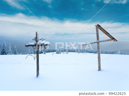 Evening winter calm mountain landscape with  wooden cross in front  (Kukol Mount, Carpathian Mountains, Ukraine) 99422625
