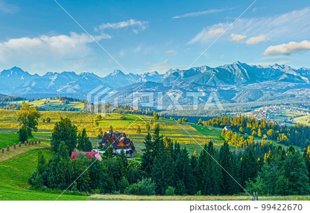 Summer mountain village outskirts and Tatra range behind (Gliczarow Dolny in valley, Poland) Summer mountain village outskirts and Tatra range behind (Gliczarow Dolny in valley, Poland) 99422670