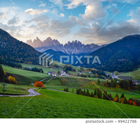 Autumn daybreak Santa Magdalena famous Italy Dolomites village view in front of the Geisler or Odle Dolomites mountain rocks. Picturesque traveling and countryside beauty concept background. 99422786