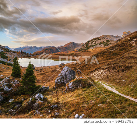Early morning autumn alpine Dolomites mountain scene. Peaceful Valparola Pass and Lake view, Belluno, Italy. Early morning autumn alpine Dolomites mountain scene. Peaceful Valparola Pass and Lake view, Belluno, Italy. 99422792