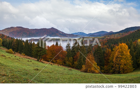 Foggy early morning autumn mountains scene. Peaceful picturesque traveling, seasonal, nature and countryside beauty concept scene. Carpathian Mountains, Ukraine. Foggy early morning autumn mountains scene. Peaceful picturesque traveling, seasonal, nature and countryside beauty concept scene. Carpathian Mountains, Ukraine. 99422803