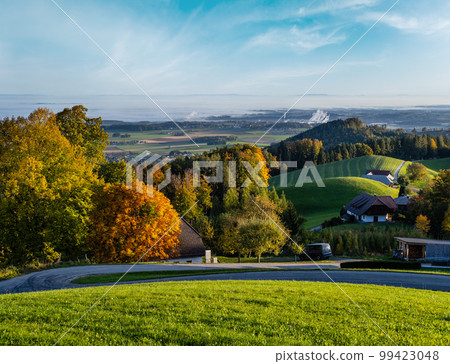 Peaceful autumn sunny morning rural view from Gmundnerberg with misty countryside in far, Austria. 99423048