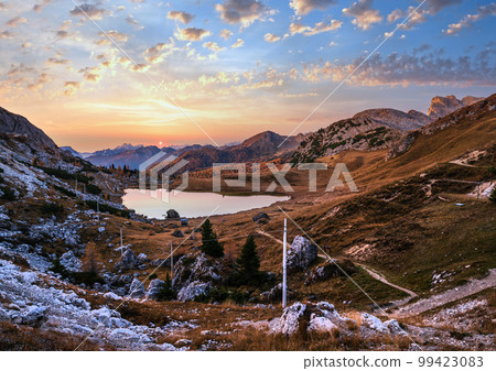 Early morning autumn alpine Dolomites mountain scene. Peaceful Valparola Path and Lake view, Belluno, Italy. Early morning autumn alpine Dolomites mountain scene. Peaceful Valparola Path and Lake view, Belluno, Italy. 99423083