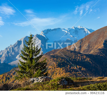 Autumn alpine Dolomites mountain scene, Sudtirol, Italy. View from Falzarego Pass to Marmolada massif and Glacier. 99423116