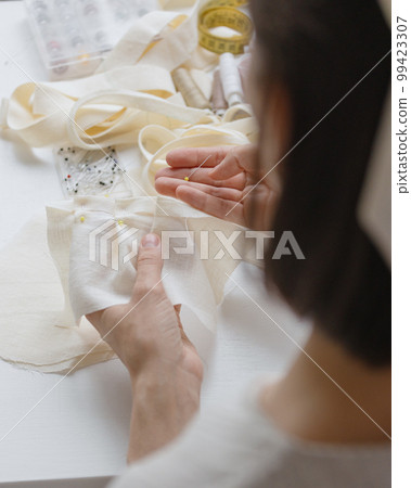 top view, woman on sewing machine creates clothes and suits, female cutter fashion designer couturier 99423307