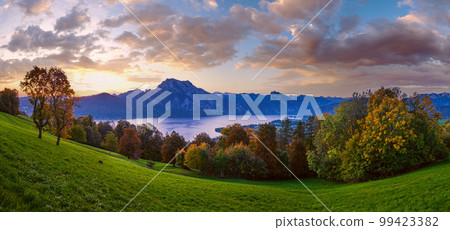 Peaceful autumn Alps mountain lake. Sunrise view to Traunsee lake, Gmundnerberg, Altmunster am Traunsee, Upper Austria. 99423382