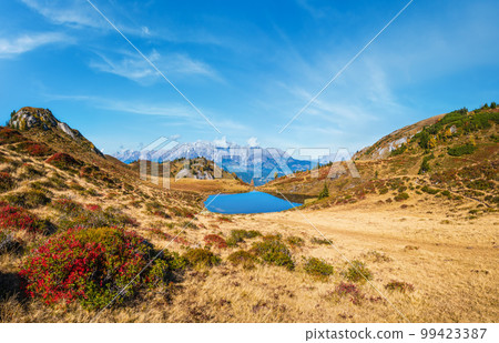 Autumn alpine Kleiner Paarsee or Paarseen lake, Land Salzburg, Austria. Alps Hochkonig rocky mountain group view in far. Autumn alpine Kleiner Paarsee or Paarseen lake, Land Salzburg, Austria. Alps Hochkonig rocky mountain group view in far. 99423387