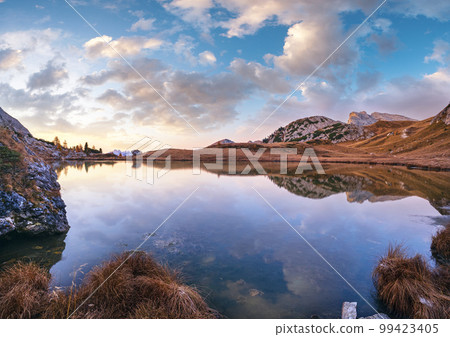Early morning autumn alpine Dolomites mountain scene. Peaceful Valparola Path and Lake view, Belluno, Italy. Early morning autumn alpine Dolomites mountain scene. Peaceful Valparola Path and Lake view, Belluno, Italy. 99423405