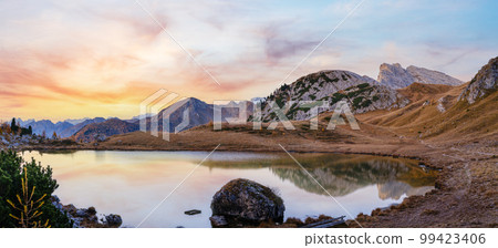 Early morning autumn alpine Dolomites mountain scene. Peaceful Valparola Pass and Lake view, Belluno, Italy. Early morning autumn alpine Dolomites mountain scene. Peaceful Valparola Pass and Lake view, Belluno, Italy. 99423406
