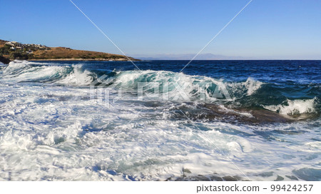 Sunny clear stormy blue sea on rocky shore, Greece 99424257