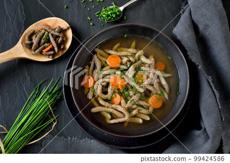 Bavarian, Swabian and Austrian dish -  liver spaetzle in a beef soup served on a dark slate plate  99424586
