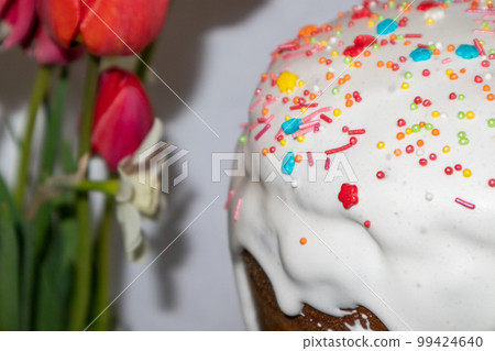 Easter holidays sweet paska with tulips close-up Easter holidays sweet paska with tulips close-up 99424640