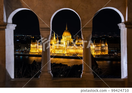 Night time view of the illuminated Hungarian Parliament Building from the Fisherman's Bastion in Budapest, Hungary. Night time view of the illuminated Hungarian Parliament Building from the Fisherman's Bastion in Budapest, Hungary. 99424710