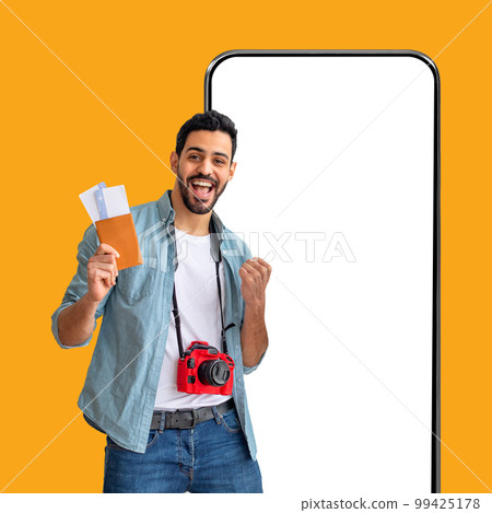 Excited middle eastern guy going vacation, gesturing on yellow 99425178