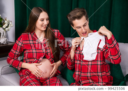 A happy couple awaiting the birth of their first child. 99425506