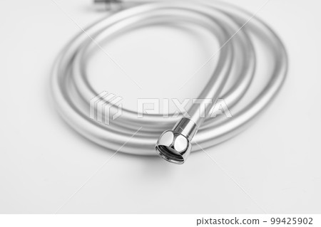 New flexible rubber shower hose on a white background. New flexible rubber shower hose on a white background. 99425902