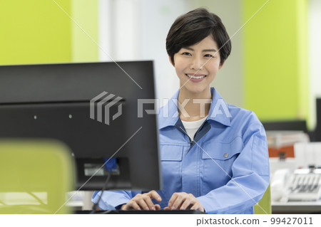 Desk work Young woman in work clothes 99427011