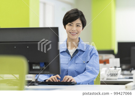 Desk work Young woman in work clothes 99427066